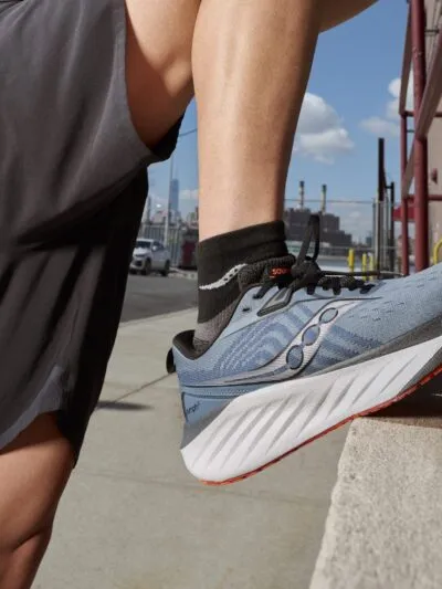 Saucony Triumph 22 lifestyle man stretching with leg up