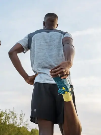 Man stretching before a run in front of the Eiffel Towerl