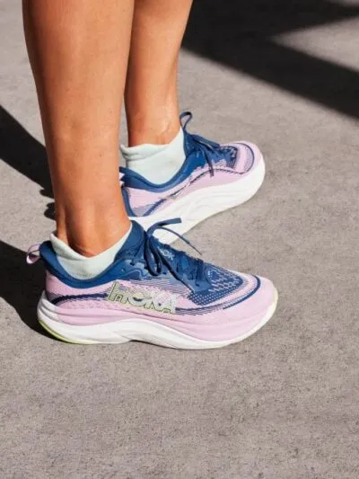 Woman wearing a pair of HOKA Skyflow running shoes