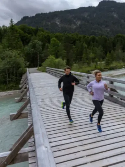 Man and woman running in a pair of Brooks running shoes