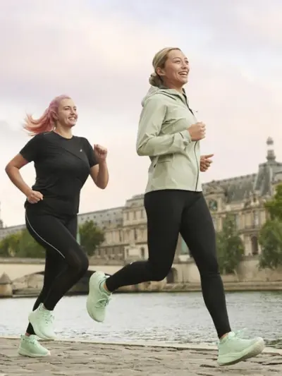 Group of a man and two women running in Asics running shoes