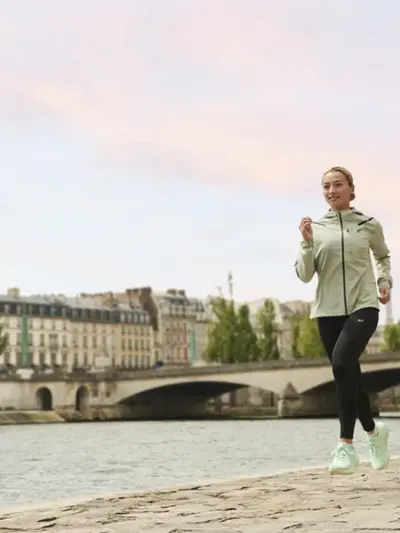 Man and woman running in a pair of Asics running shoes