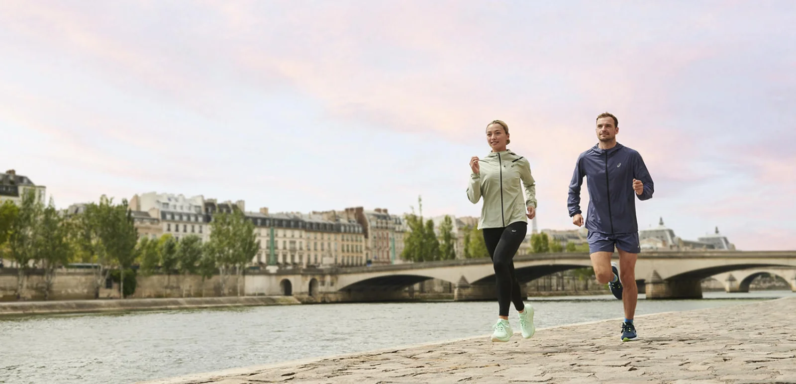 Man and woman running in a pair of Asics running shoes