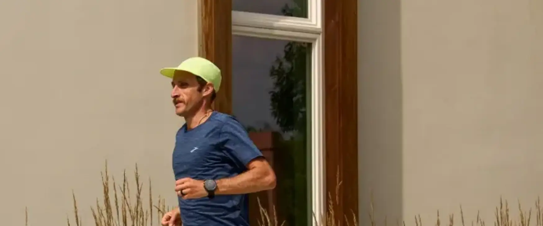 Man running on a sidewalk in a pair of Brooks running shoes