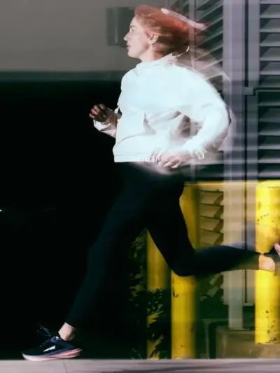 woman running down street in altra torin