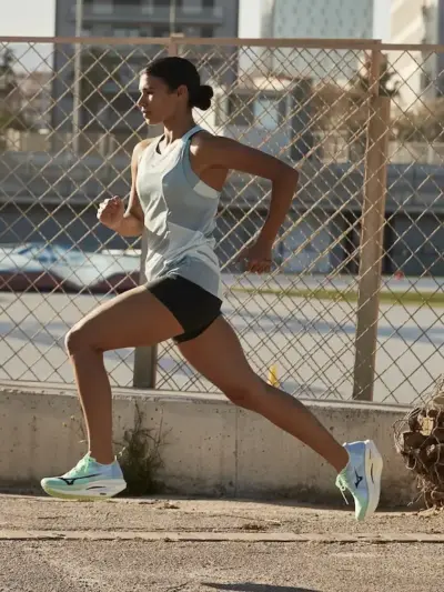 woman running down street in mizuno shoes