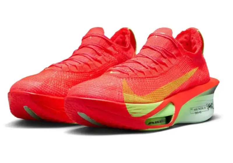 Front-angle view of a pair of Nike Alphafly 3 running shoes in crimson red with lime green midsoles, gold swooshes, and visible Air Zoom pods under the forefoot.