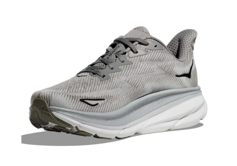 Angled view of a men's grey Hoka Clifton 9 running shoe featuring a white and grey cushioned sole and black Hoka wing logo near the heel.