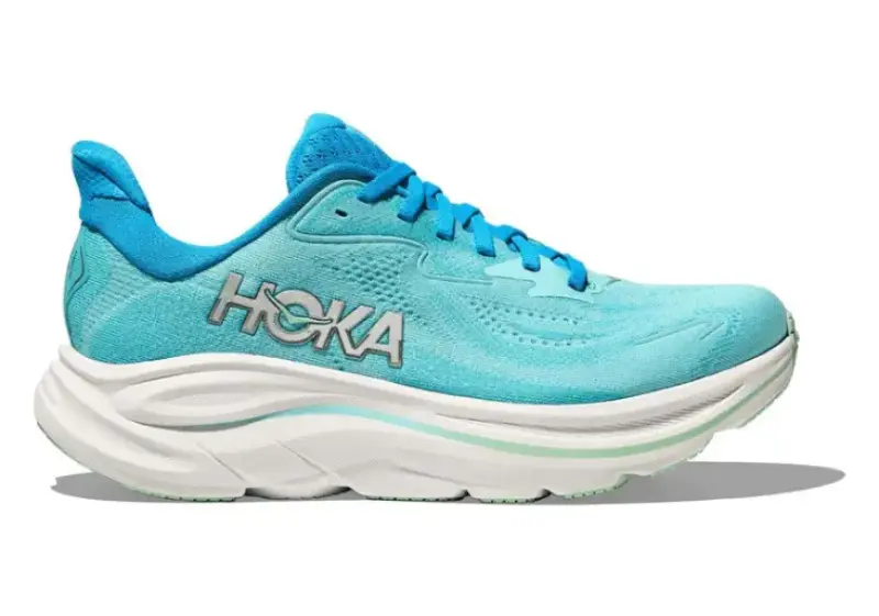 Side view of a women's black Hoka Clifton 10 running shoe with a white cushioned sole and subtle Hoka wing logo near the heel.
