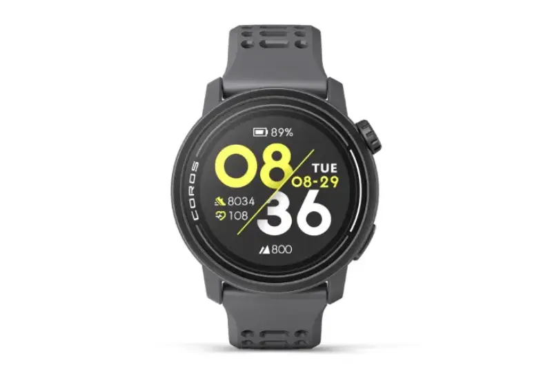 Front view of the Coros Pace 3 smartwatch with a gray band, showing a digital display with bold yellow and white numbers, step count, heart rate, battery level, and date.