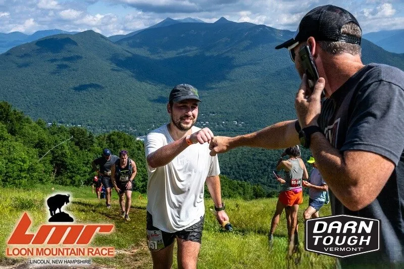 Loon Mountain Race runner on trail fist bumping spectator
