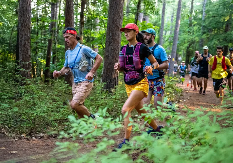 People running on aa trail in the woods