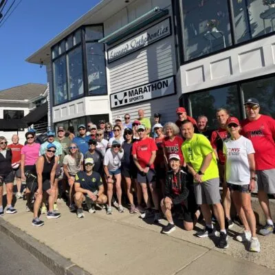 Group photo of runners at the Marathon Sports run group outside the store