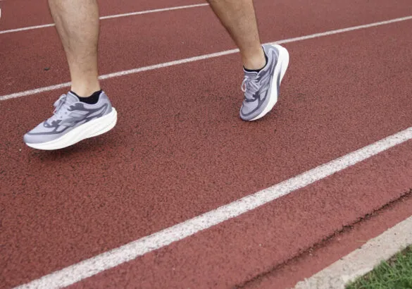 man running in new balance sc rebel on track